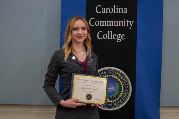 Student displaying Academic Excellence Award