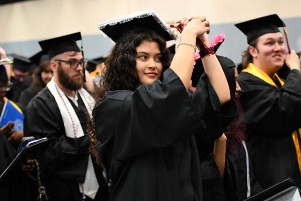 Students moving tassel at 11 a.m. Graduation