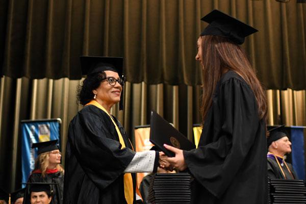 Student shacking hands and receiving diploma 