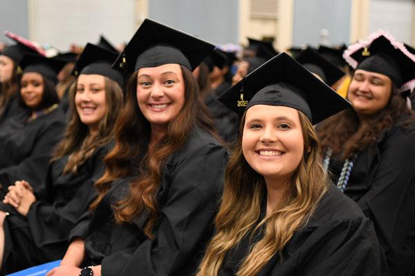 Smiling students at 9 a.m. Graduation